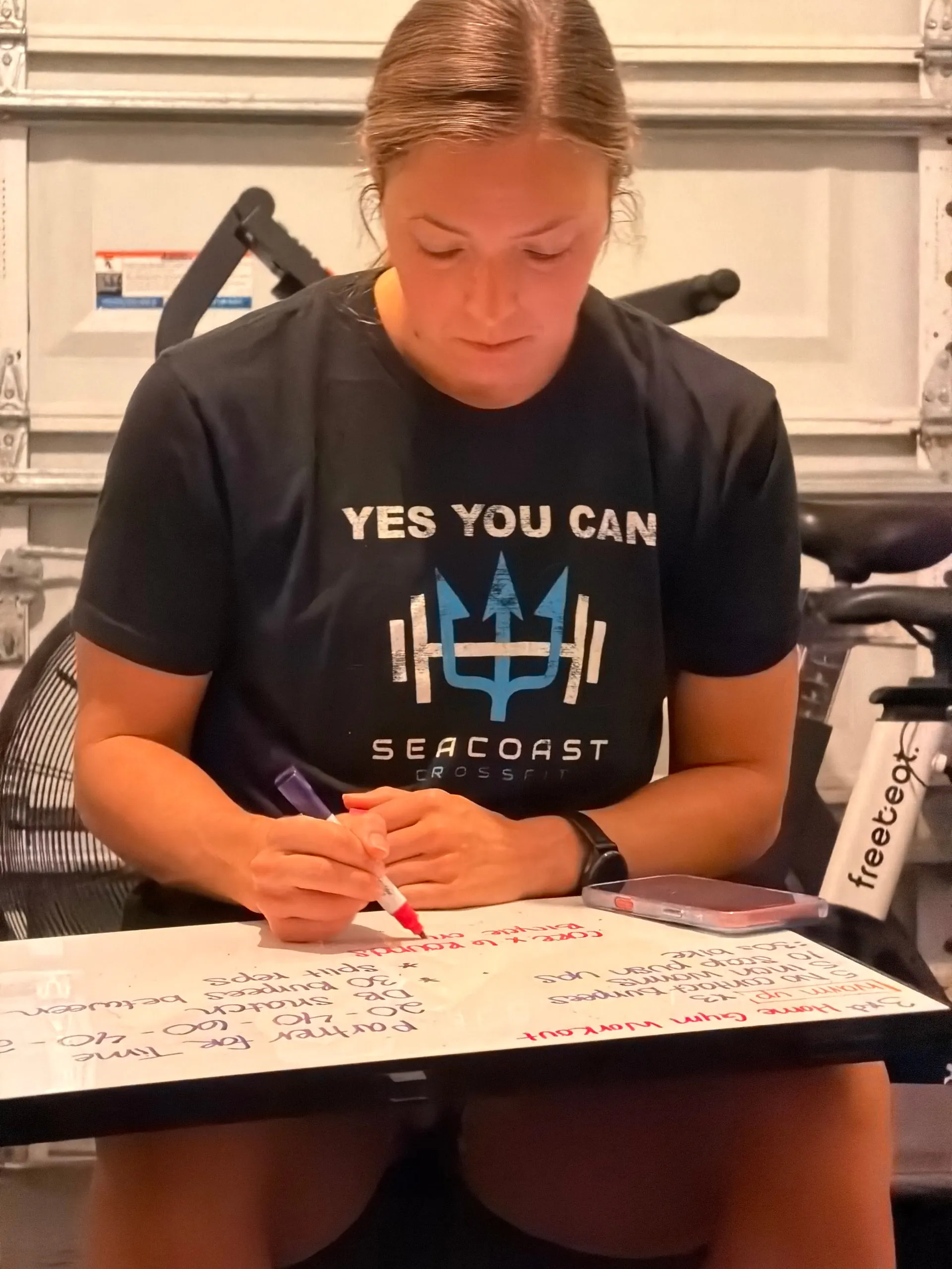 Lexi writing the day’s training session out on a whiteboard