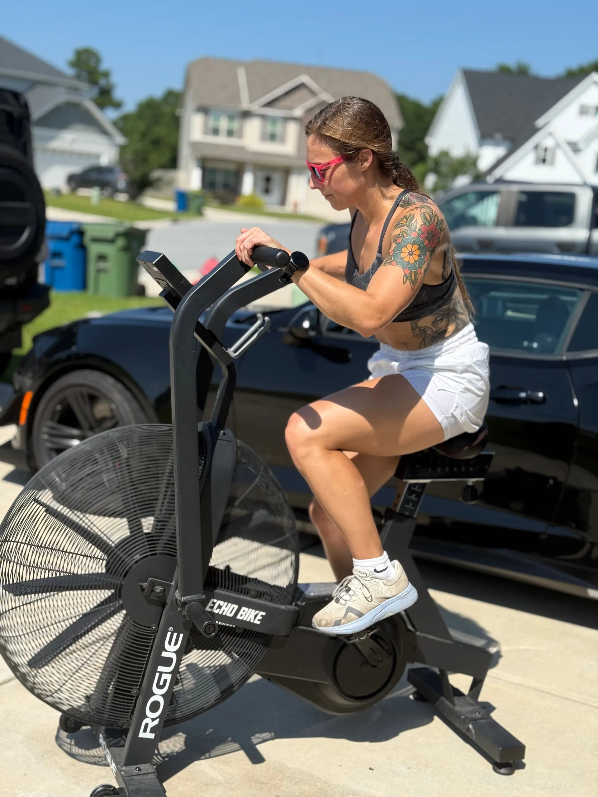 Lexi training on an air bike in a driveway